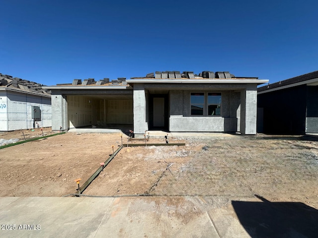 unfinished property featuring an attached carport