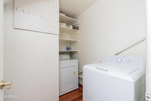 clothes washing area featuring dark hardwood / wood-style floors and separate washer and dryer