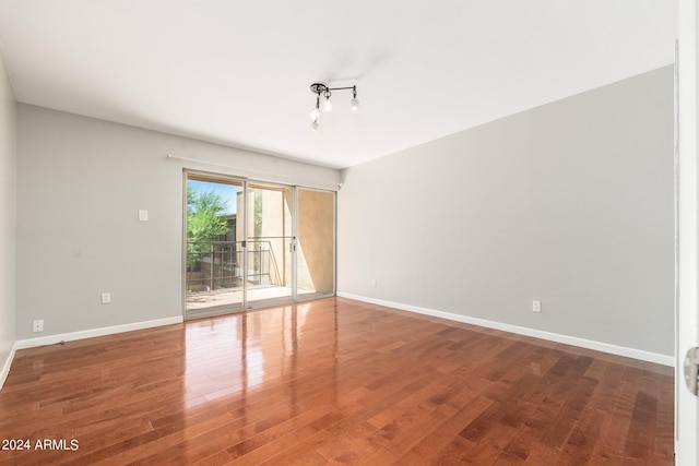 empty room with hardwood / wood-style flooring