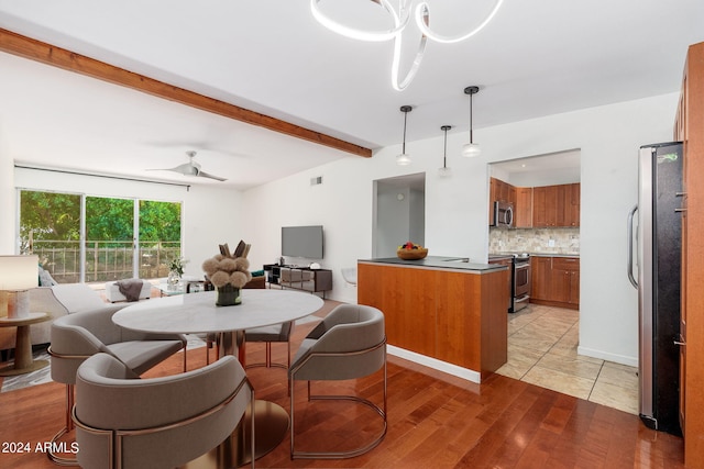 dining area with ceiling fan with notable chandelier, light hardwood / wood-style floors, and beam ceiling