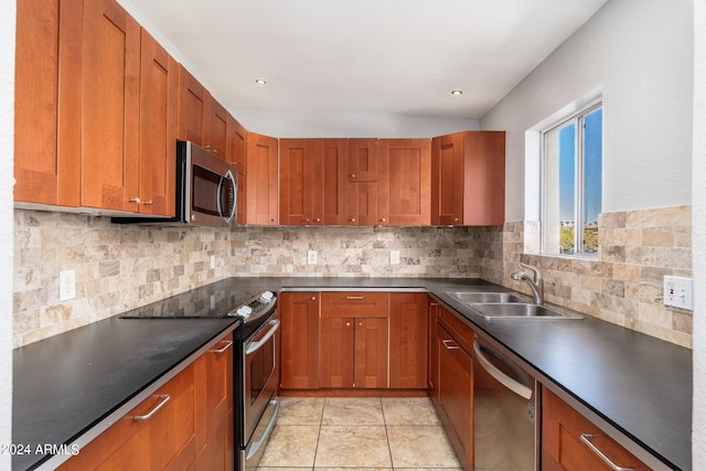 kitchen featuring light tile patterned floors, stainless steel appliances, sink, and tasteful backsplash