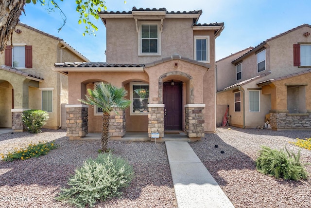 9 N 87th Ln N, Tolleson, AZ 85353 - mediterranean / spanish house with a tiled roof, stucco siding, and stone siding