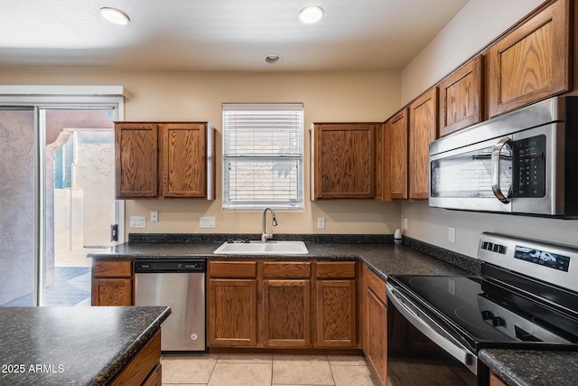 9 N 87th Ln N, Tolleson, AZ 85353 - kitchen with appliances with stainless steel finishes, a sink, plenty of natural light, and dark countertops