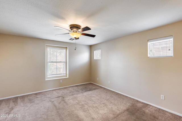 9 N 87th Ln N, Tolleson, AZ 85353 - carpeted spare room with healthy amount of natural light, a ceiling fan, and baseboards