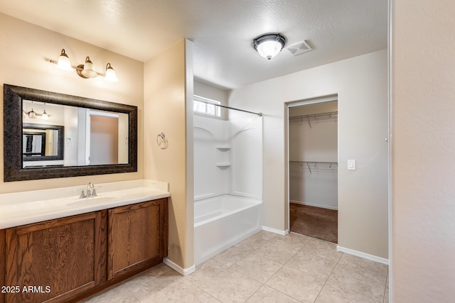 9 N 87th Ln N, Tolleson, AZ 85353 - full bathroom featuring vanity, shower / bathtub combination, tile patterned floors, and baseboards