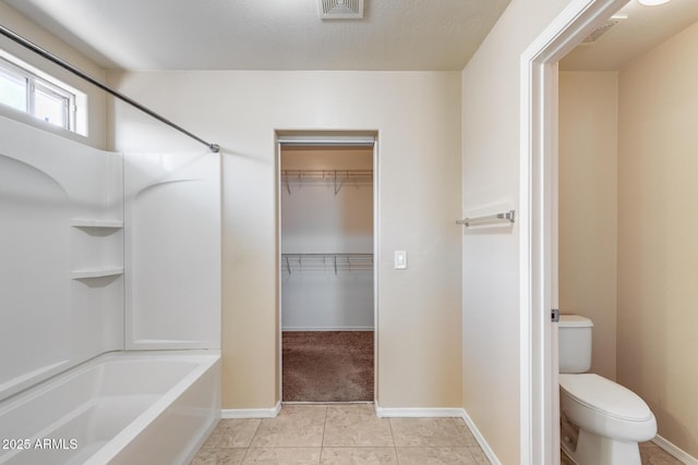 9 N 87th Ln N, Tolleson, AZ 85353 - full bathroom featuring toilet, shower / bathtub combination, baseboards, and tile patterned flooring