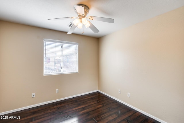 9 N 87th Ln N, Tolleson, AZ 85353 - spare room featuring dark wood-style floors, baseboards, and a ceiling fan