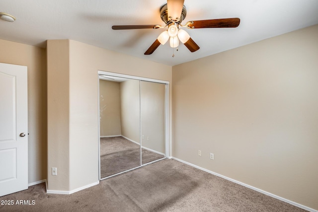 9 N 87th Ln N, Tolleson, AZ 85353 - unfurnished bedroom featuring carpet floors, a closet, baseboards, and a ceiling fan