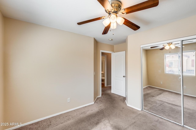 9 N 87th Ln N, Tolleson, AZ 85353 - unfurnished bedroom featuring carpet flooring, a closet, baseboards, and a ceiling fan