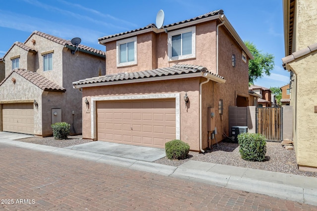 9 N 87th Ln N, Tolleson, AZ 85353 - view of front of house with a tiled roof, stucco siding, an attached garage, concrete driveway, and a gate