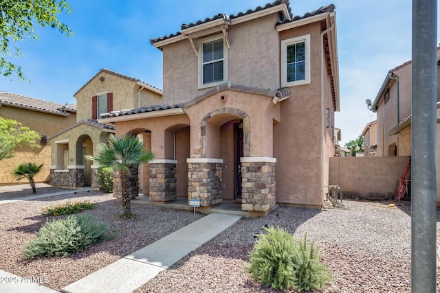 9 N 87th Ln N, Tolleson, AZ 85353 - view of front of property featuring stucco siding, a tile roof, and stone siding