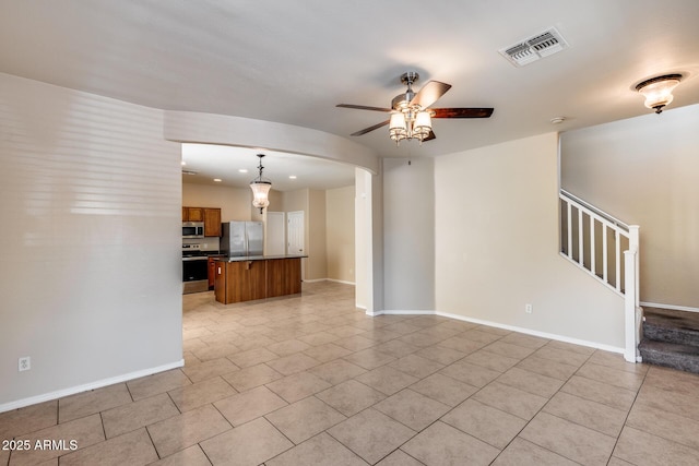 9 N 87th Ln N, Tolleson, AZ 85353 - unfurnished living room with a ceiling fan, light tile patterned flooring, arched walkways, stairway, and recessed lighting