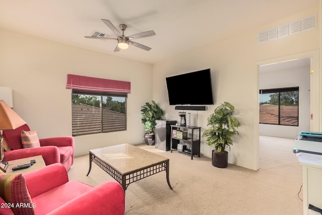 carpeted living room featuring a wealth of natural light and ceiling fan