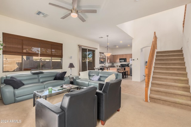 carpeted living room with ceiling fan