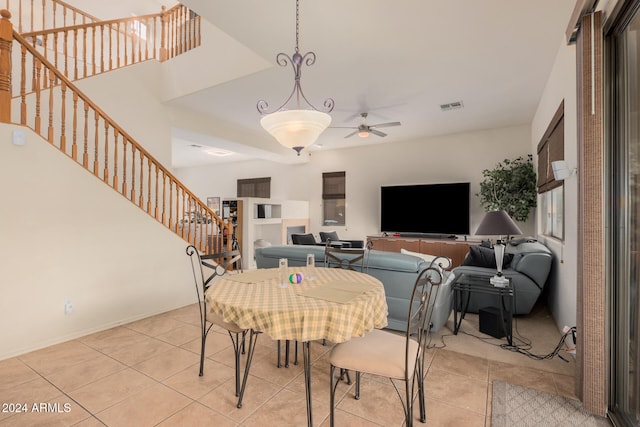 tiled dining space featuring ceiling fan