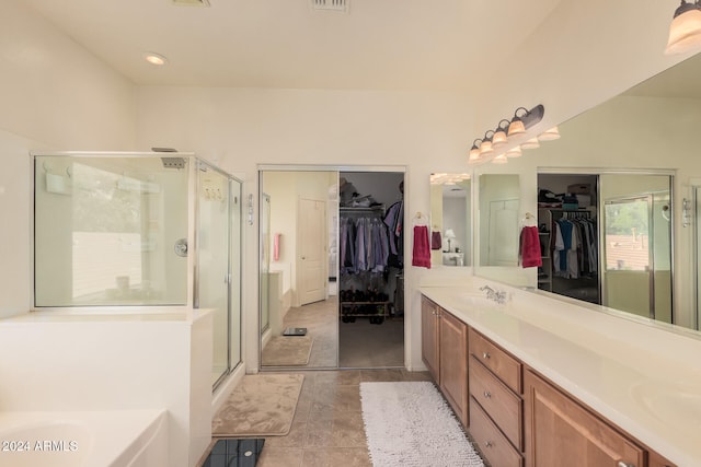 bathroom with vanity, tile patterned floors, and separate shower and tub