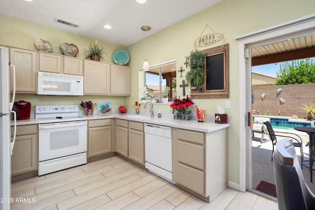 15790 W Arrowhead Dr, Surprise, AZ 85374 - kitchen featuring white appliances, healthy amount of natural light, light countertops, pendant lighting, and recessed lighting