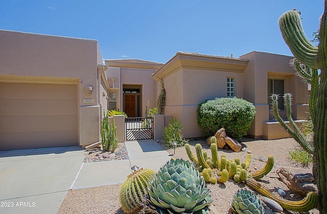 pueblo revival-style home with a garage