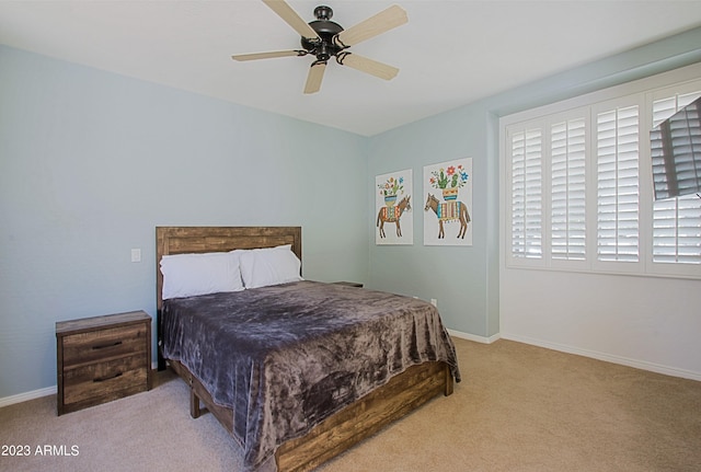 bedroom with light colored carpet and ceiling fan