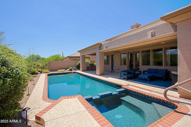 view of swimming pool with an outdoor living space and a patio