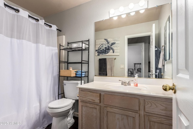 bathroom with walk in shower, vanity, and toilet