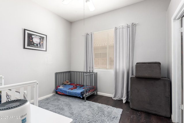 bedroom with ceiling fan and dark hardwood / wood-style floors