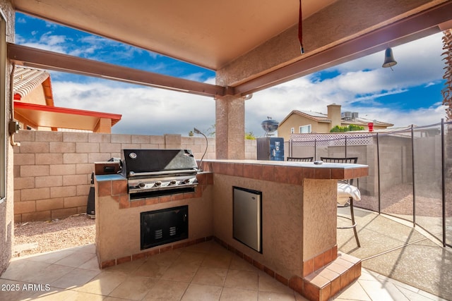 view of patio with area for grilling and grilling area