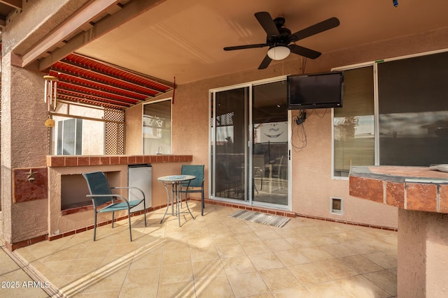 view of patio with ceiling fan and a jacuzzi