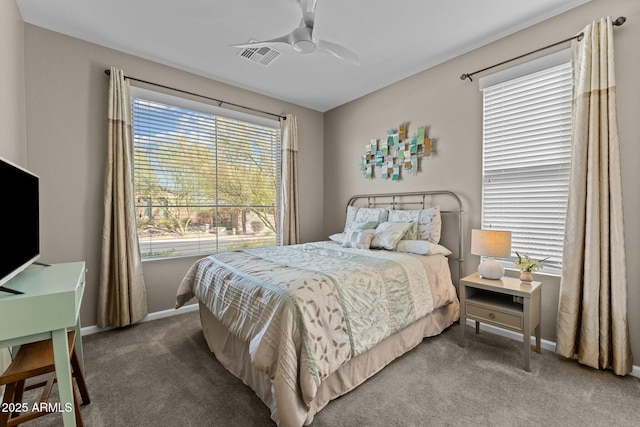 carpeted bedroom with ceiling fan, visible vents, and baseboards