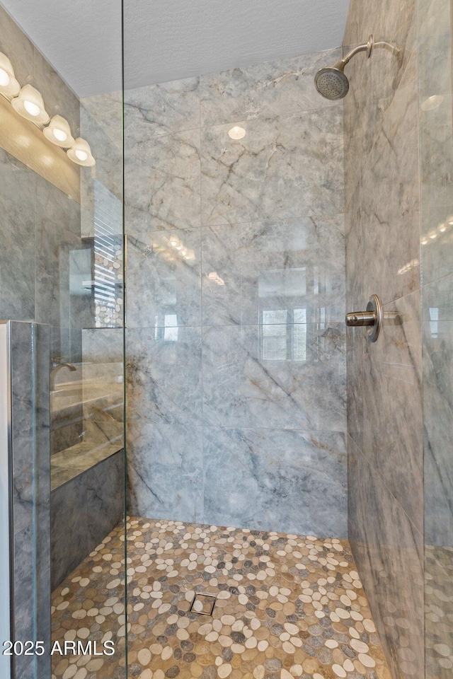 full bathroom with a tile shower