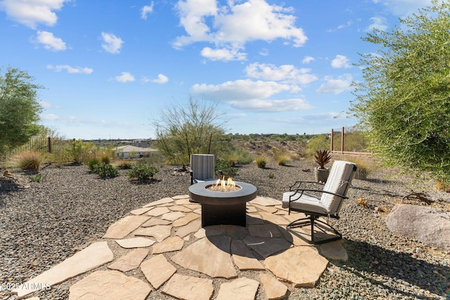 view of patio / terrace featuring an outdoor fire pit and fence