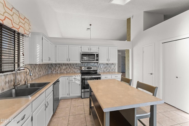 kitchen featuring tasteful backsplash, stainless steel appliances, white cabinetry, a textured ceiling, and sink