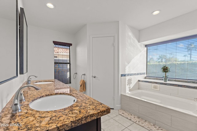 bathroom featuring vanity, tiled bath, and tile patterned floors