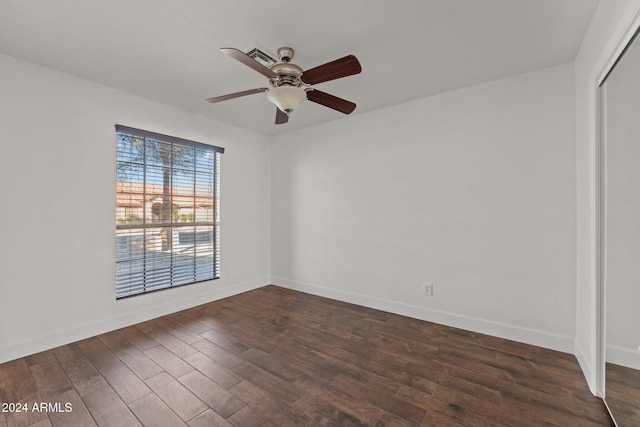 spare room featuring ceiling fan and dark hardwood / wood-style floors