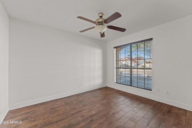 empty room with dark hardwood / wood-style floors and ceiling fan