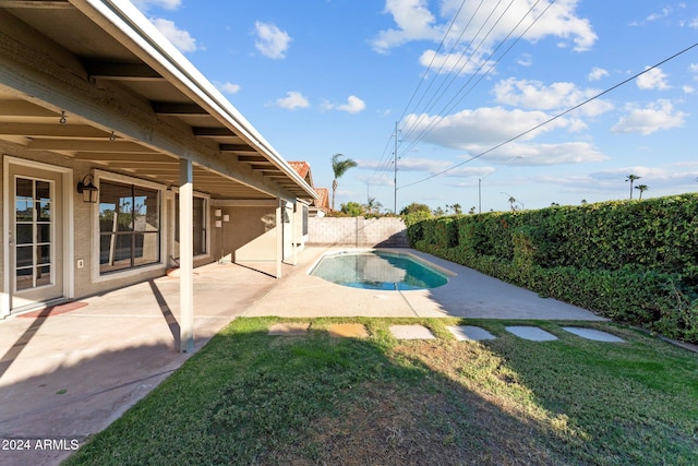 view of pool featuring a yard and a patio area