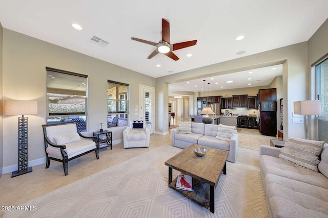 living room with recessed lighting, ceiling fan, visible vents, and plenty of natural light