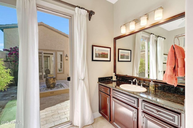 bathroom with a healthy amount of sunlight, vanity, and tile patterned floors