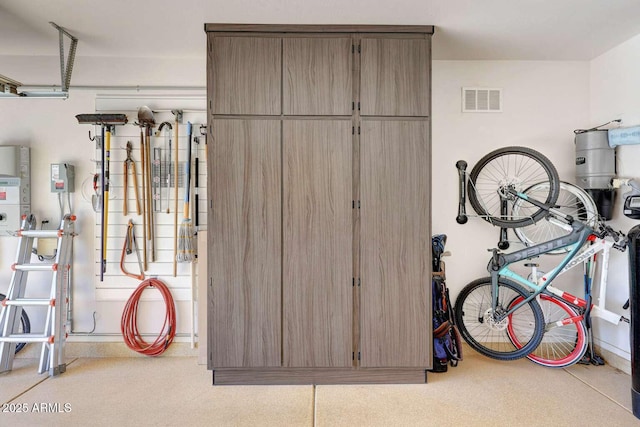 garage with baseboards and visible vents