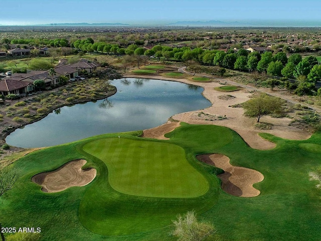 drone / aerial view featuring a water and mountain view, golf course view, and a residential view