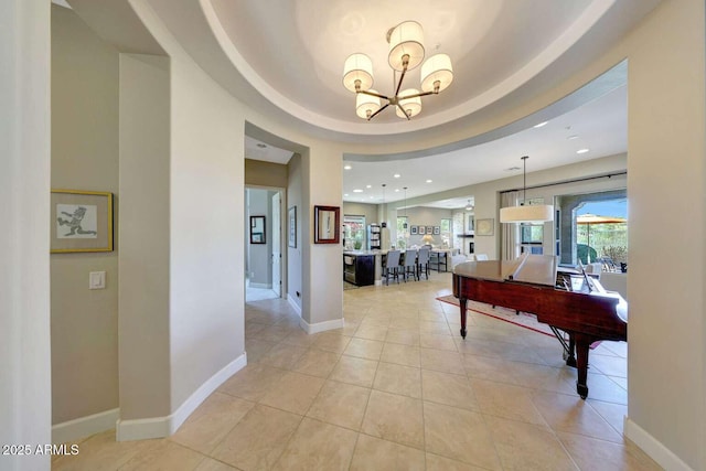 entryway with light tile patterned floors, baseboards, recessed lighting, and a notable chandelier