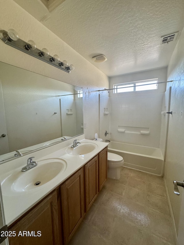 bathroom with shower / tub combination, a sink, double vanity, and toilet