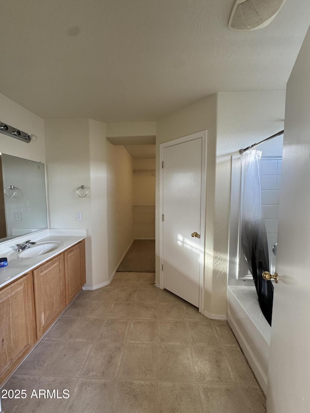 full bathroom featuring vanity, baseboards, and shower / bathtub combination with curtain