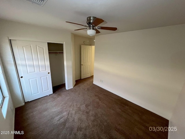 unfurnished bedroom featuring a ceiling fan, carpet, a closet, and baseboards