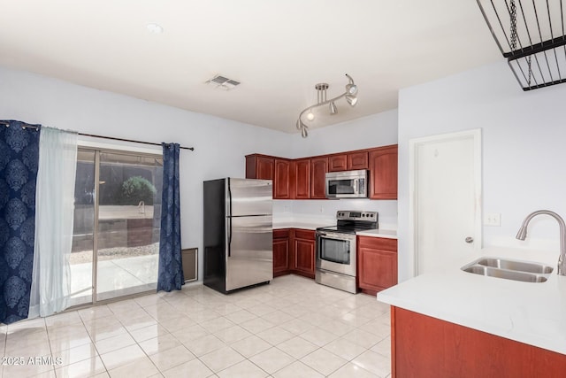 kitchen with visible vents, light countertops, light tile patterned floors, appliances with stainless steel finishes, and a sink