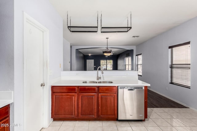 kitchen with visible vents, a peninsula, a sink, light countertops, and stainless steel dishwasher