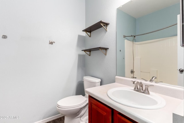 bathroom with vanity, toilet, and walk in shower