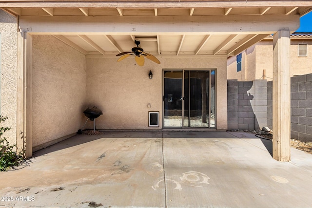 view of patio / terrace with a ceiling fan and fence