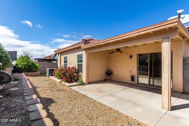 rear view of property featuring a ceiling fan, fence, stucco siding, a tile roof, and a patio area