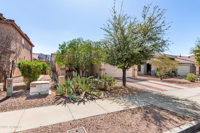 obstructed view of property with stucco siding, an attached garage, and concrete driveway